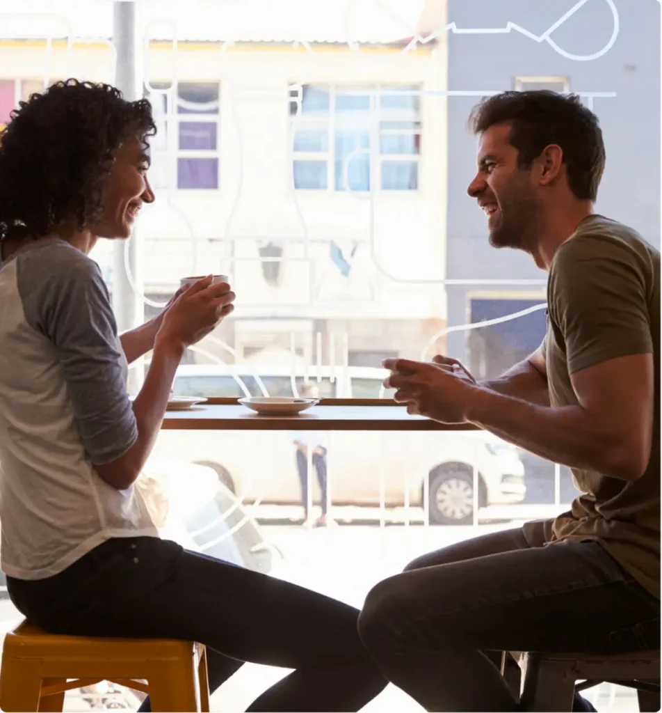 Two adults talking and smiling together, representing connection and emotional support during anxiety recovery.