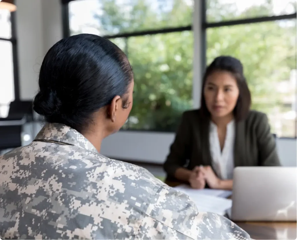 Veteran in PTSD therapy session receiving trauma-informed mental health treatment.