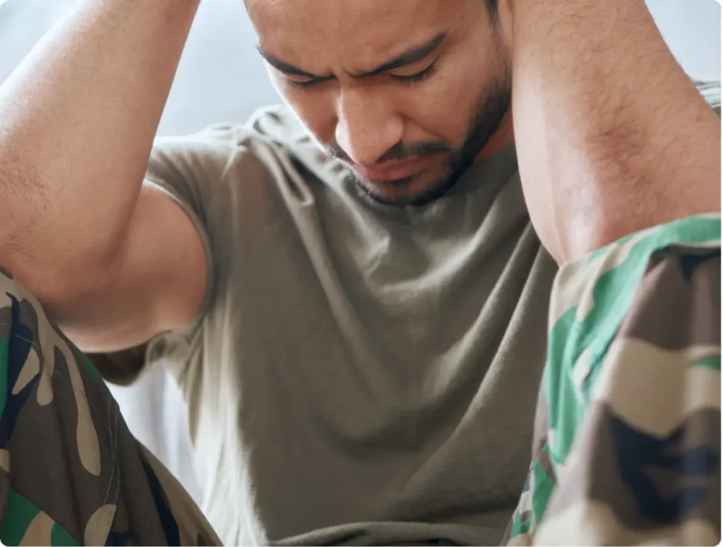 Man coping with trauma-related stress linked to addiction and mental health disorders.